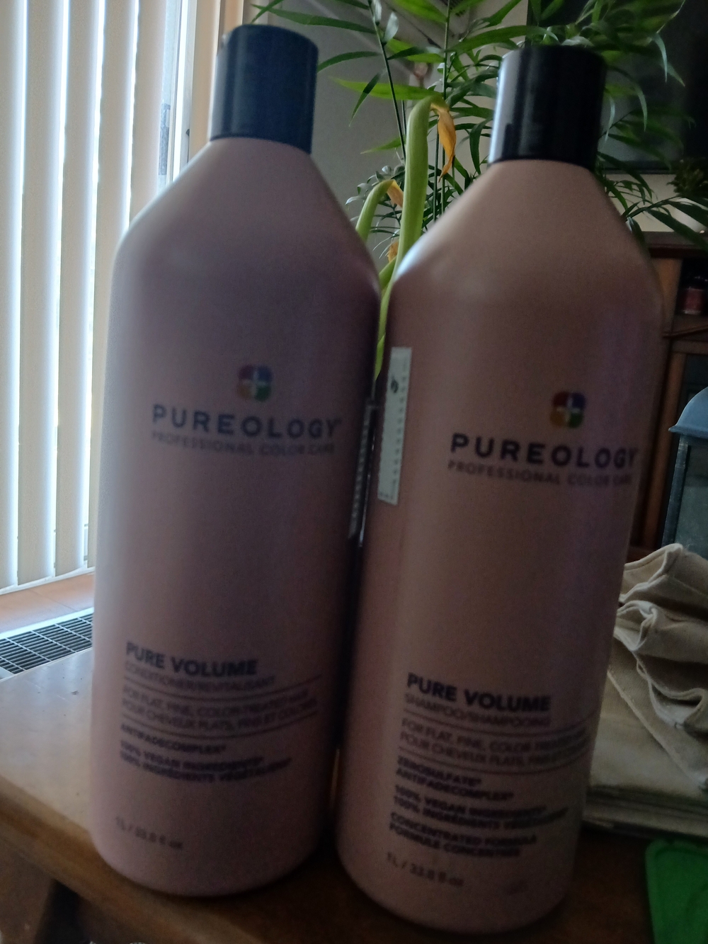 Pureology Pure Volume Shampoo Bottles in Dusty Rose with Black Caps